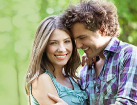 couple hugging with green background