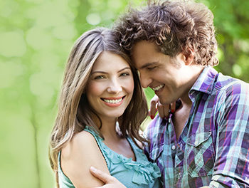 couple hugging with green background
