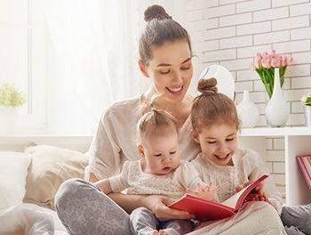 Young mum reading to her babies