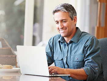 Man using his laptop to find a work life balance