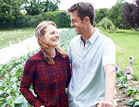 happy couple in field outside