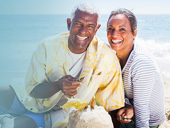 black couple laughing at the beach