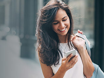 women smiling look at phone