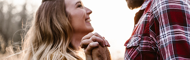 couple outside smiling and holding hands