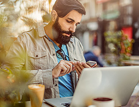 asian man outside checking his phone