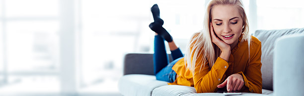 woman on sofa looking at her phone