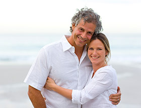 couple in white on a beach
