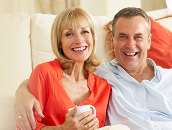 man with arm around woman