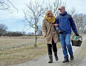 An elderly couple on their way for a picnic