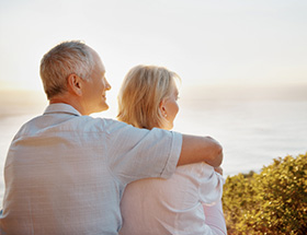 Elderly couple watching sunset