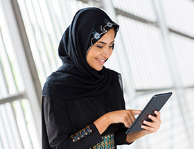 Muslim woman using her tablet