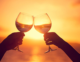 two wine glasses in the sunset