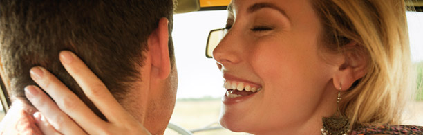 couple in a car laughing on a date