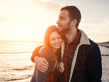 attractive couple on a beach at sunset