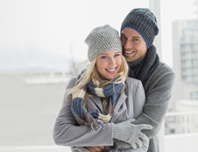 couple in winter clothing hugging