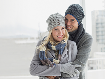 couple in winter clothing hugging