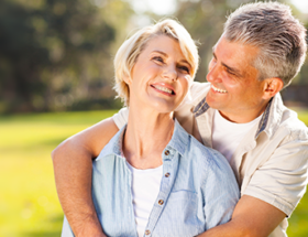 happy couple outside on grass