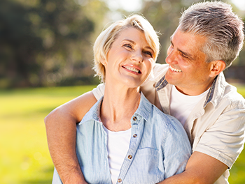 happy couple outside on grass