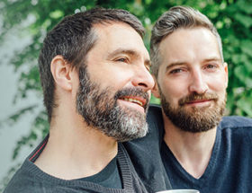 handsome bearded gay couple outside