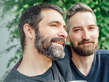 handsome bearded gay couple outside