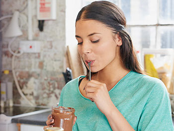 woman eating chocolate from a jar