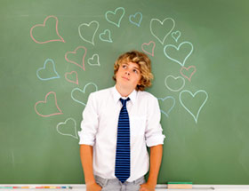 child in front of blackboard