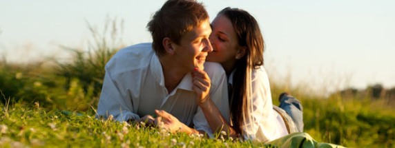 couple kissing on grass