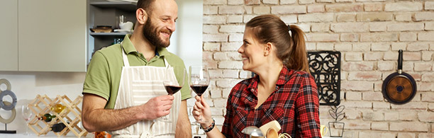 couple toasting wine in a kitchen