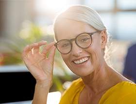 pretty older woman with glasses smiling