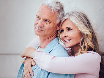 happy older couple hugging