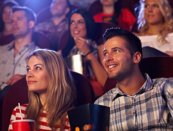 couple sitting in cinema smiling