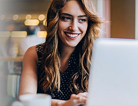 pretty woman looking at a laptop