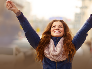 happy single woman with arms in the air