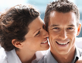 woman kissing man's cheek