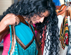 indian woman choosing a sari